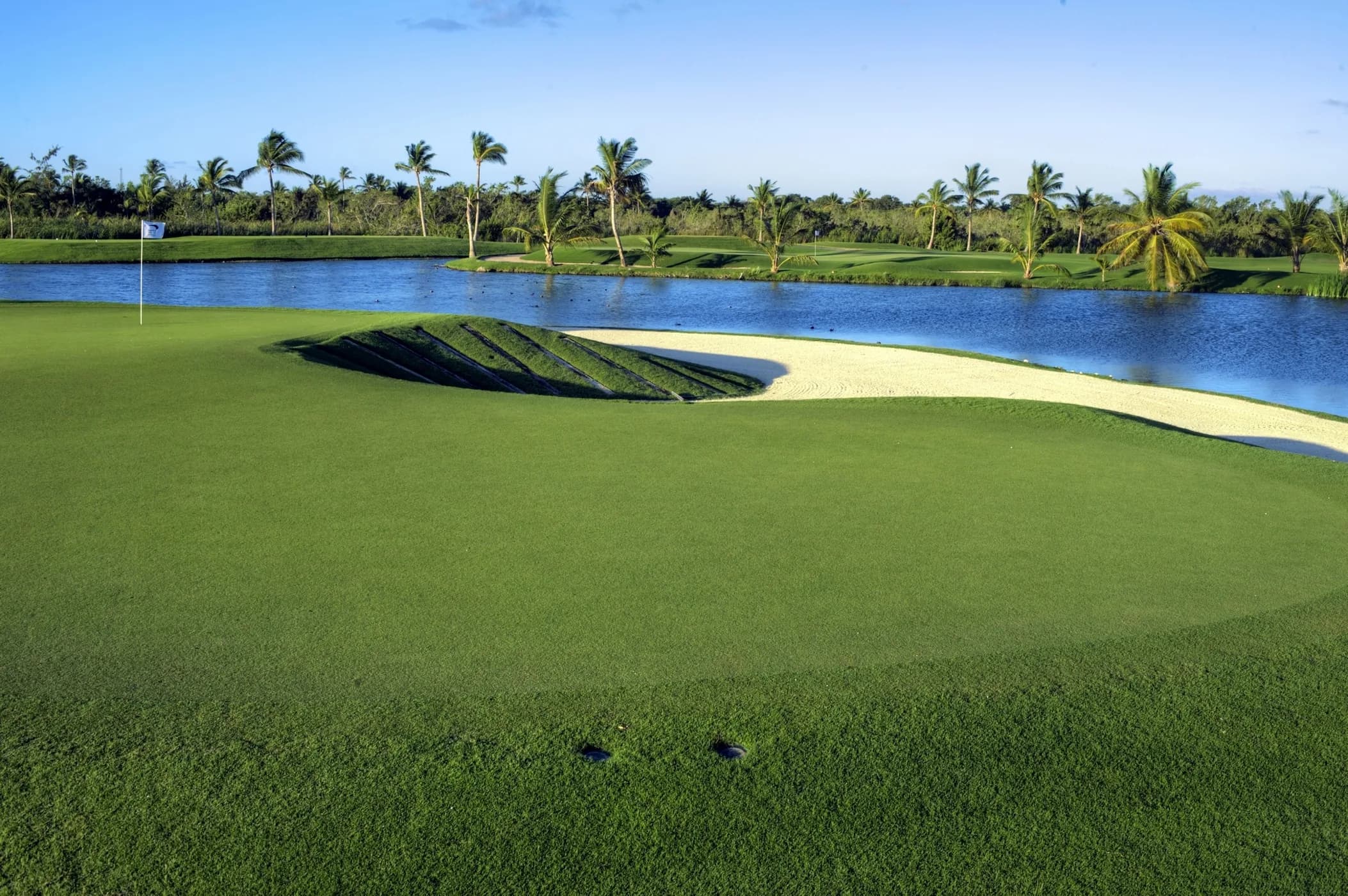 Slatted P.B. Dye bunker beside a lake and green at The Lakes Barceló