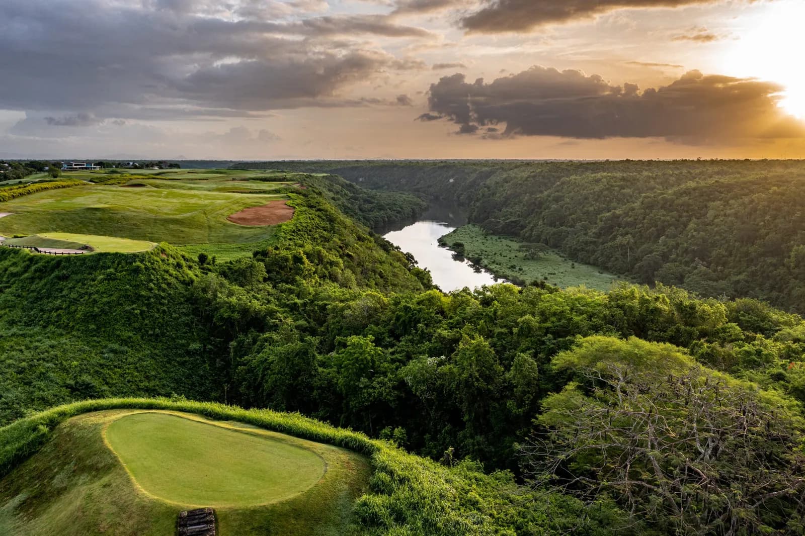 Sunset aerial of a Dye Fore tee on the cliff edge above the Chavón river