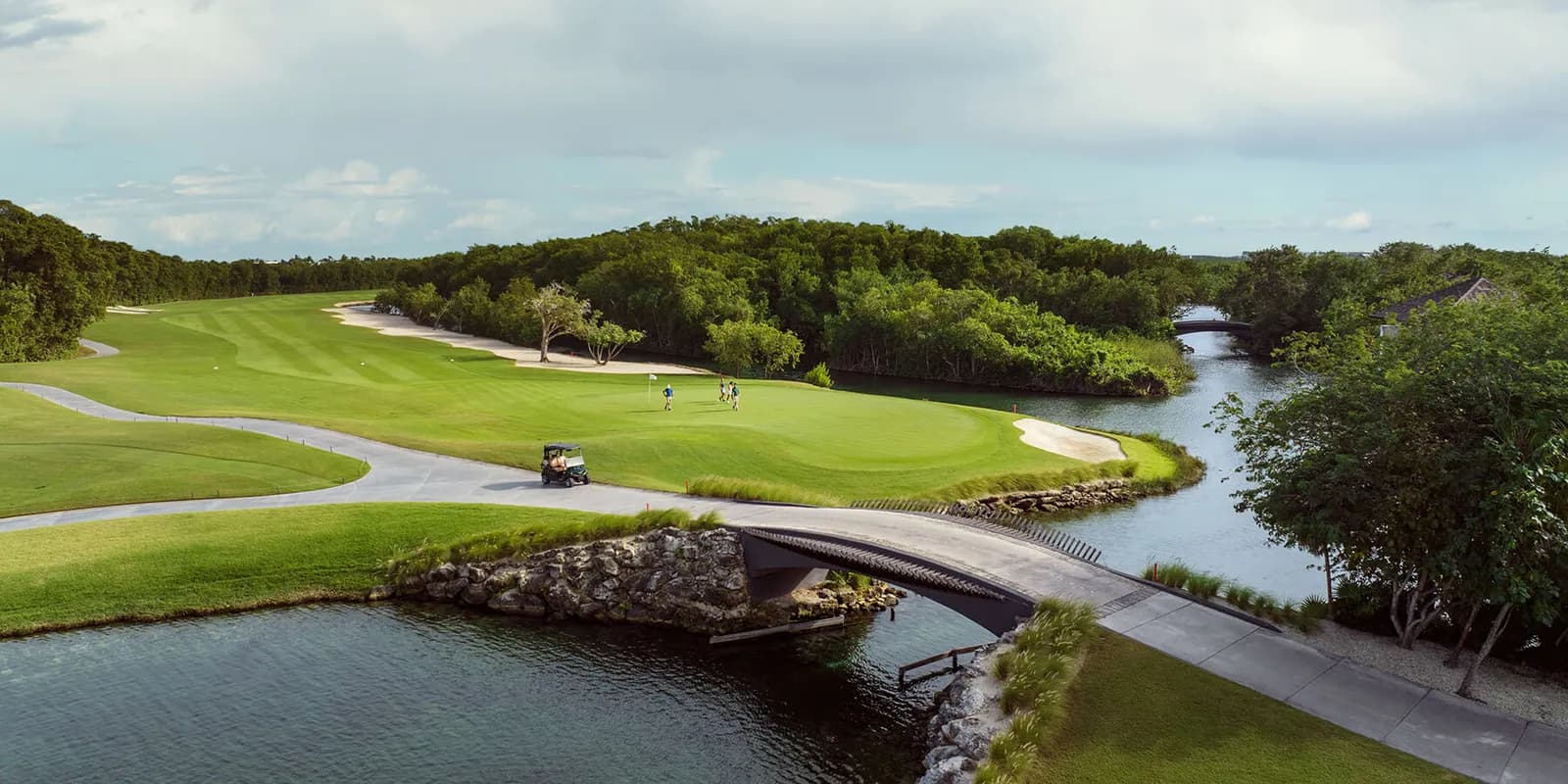 Aerial of El Camaleón fairways woven through mangrove canals