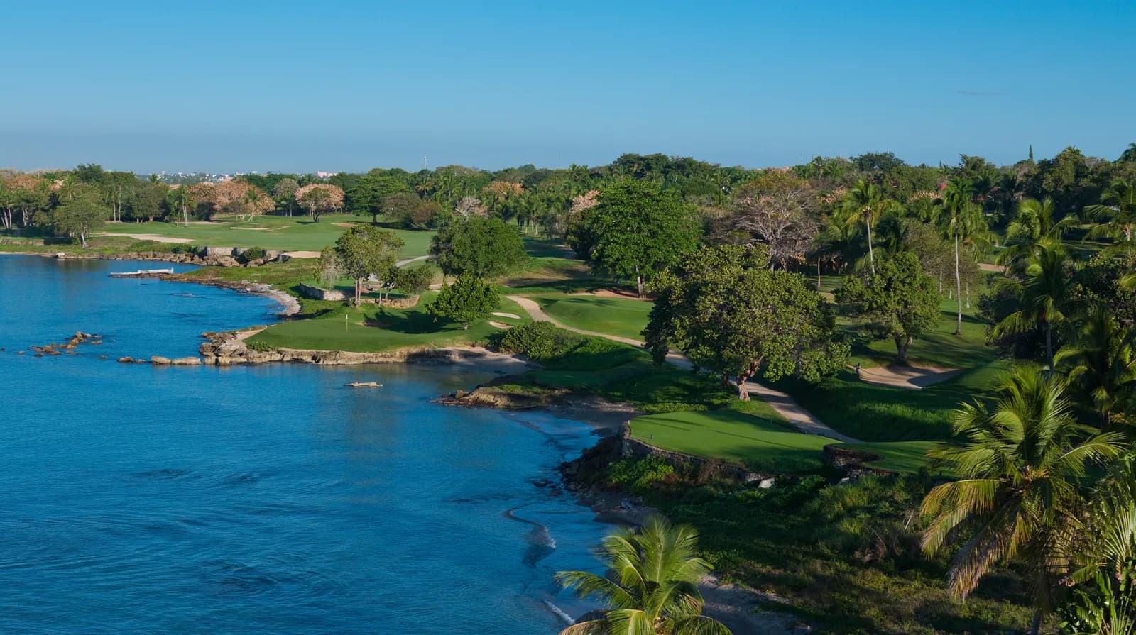 Aerial view of Teeth of the Dog’s oceanside holes, greens set on coral points along the deep-blue Caribbean.