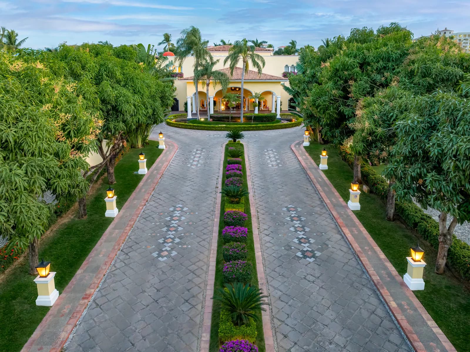 Arrival at Casa Velas — a lantern-lined drive to a private hacienda inside the Marina Vallarta golf course.