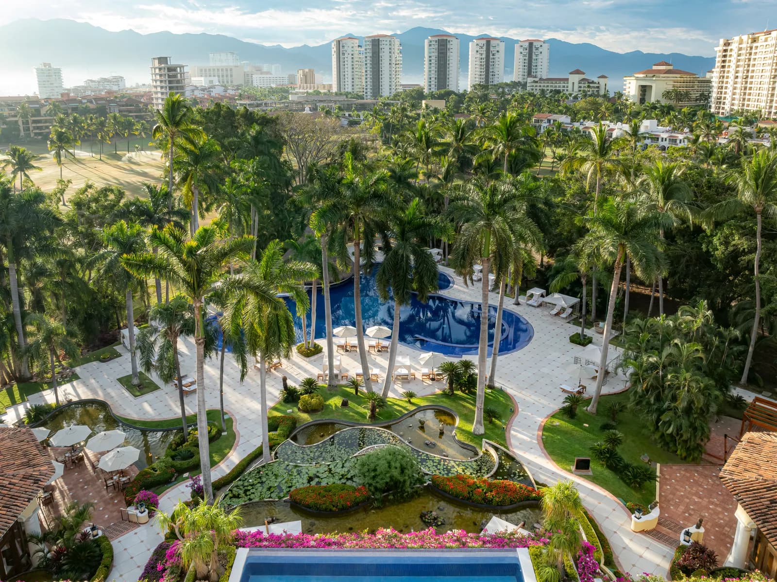 Where it sits: fairways on one side, Puerto Vallarta and the Sierra Madre on the horizon.