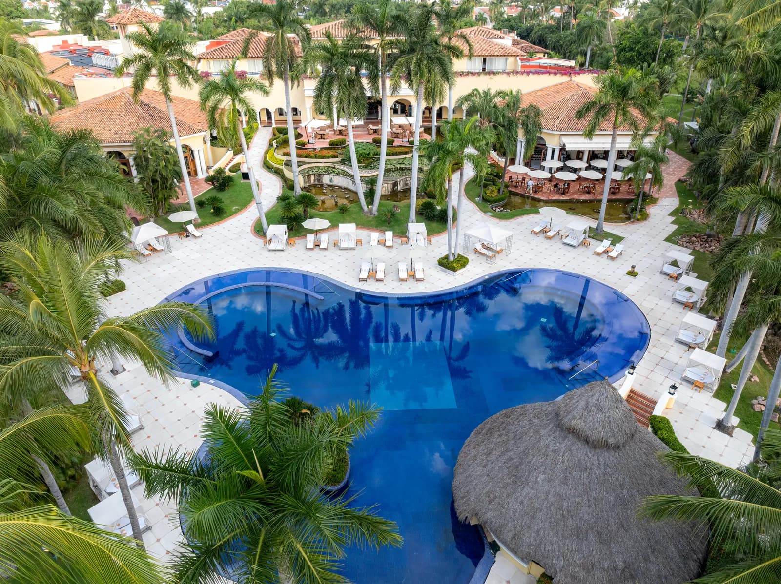 Cabanas, loungers and lily ponds — at eighty suites, it never feels like a resort pool.