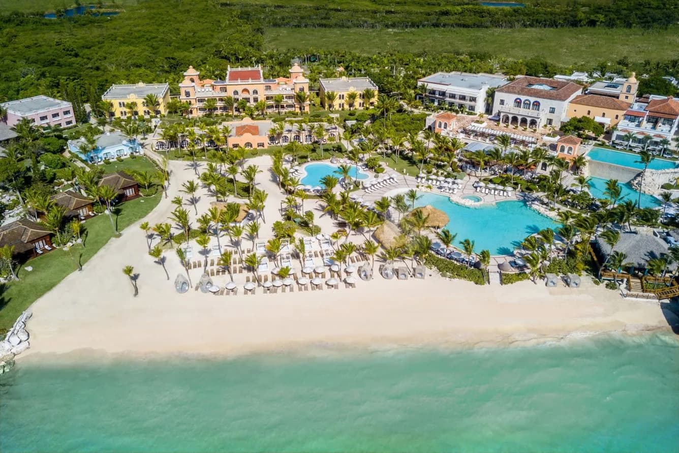 Sanctuary Cap Cana from above — Spanish colonial villas, a chain of pools, and the beach beyond.