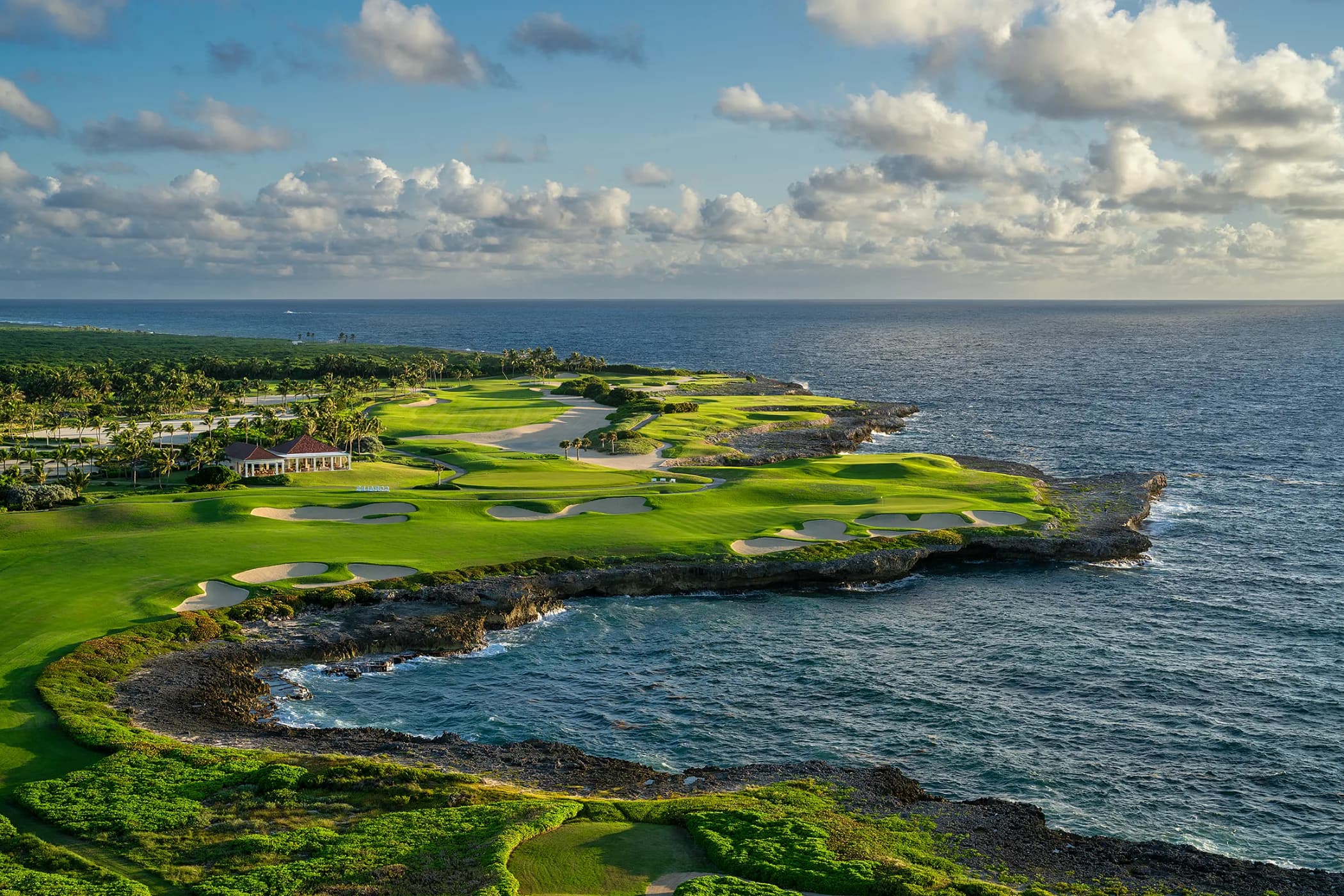 The par 4 eighteenth at Corales at sunrise, its fairway running out toward the Caribbean.